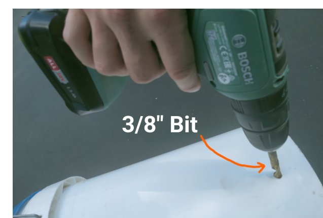Drilling a 3/8 inch hole near the base of a bucket