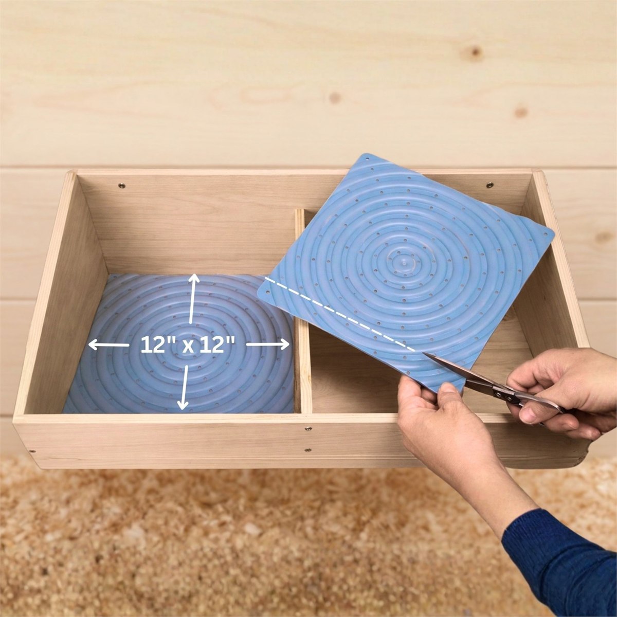 A pad measured at 12 by 12 inches in a nest box, and a second pad being cut down with scissors