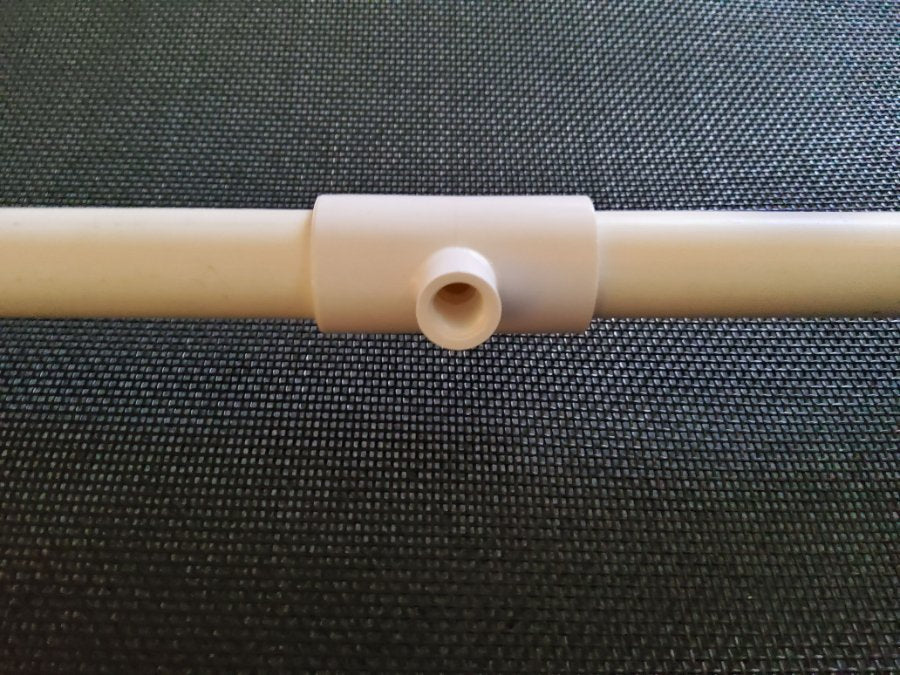 A tee cemented into a length of 1/2 inch PVC pipe